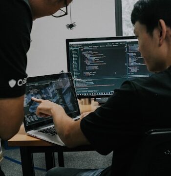 two men working-on computers