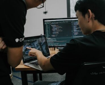 two men working-on computers