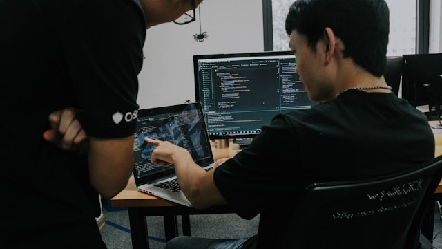 two men working-on computers